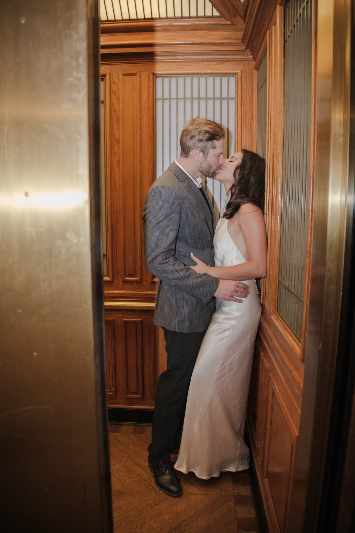 Couple kissing in the elevator at San Francisco City Hall, direct flash wedding photography by Matt Dea