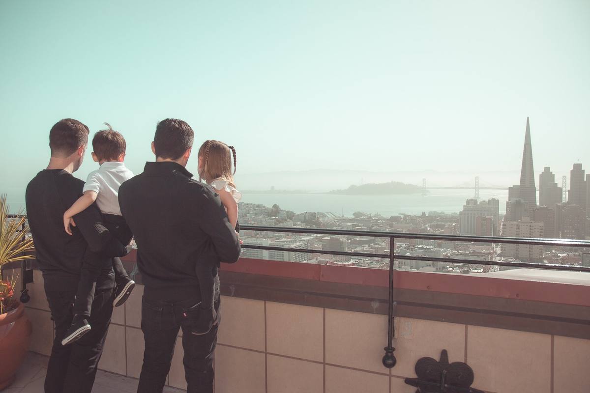Family on the rooftop looking toward the Transamerica Pyramid and Alcatraz