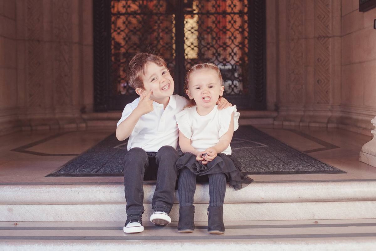 Brother and sister being silly on the entry steps of their Nob Hill building