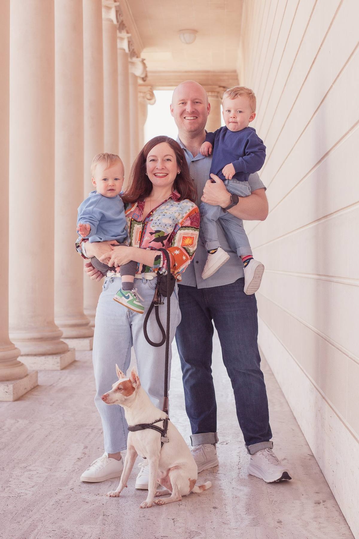 Family of four with their dog among the columns of the Legion of Honor courtyard