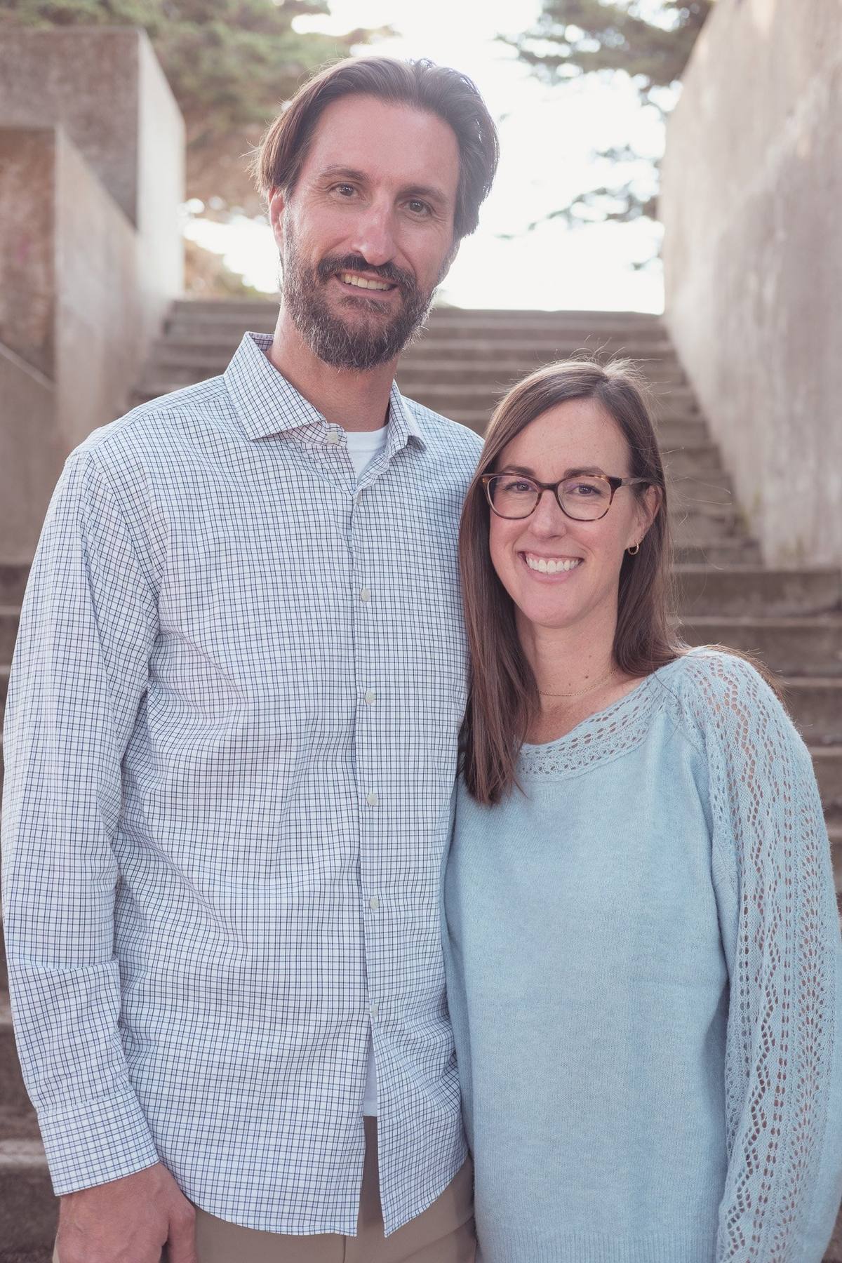 Couple smiling together beside the stone stairs at Sutro Park