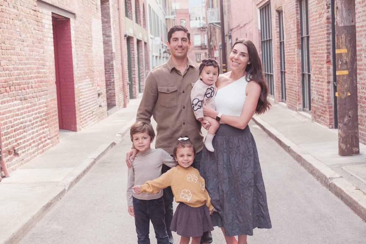 Parents with their three children in a quiet brick alley in downtown San Francisco