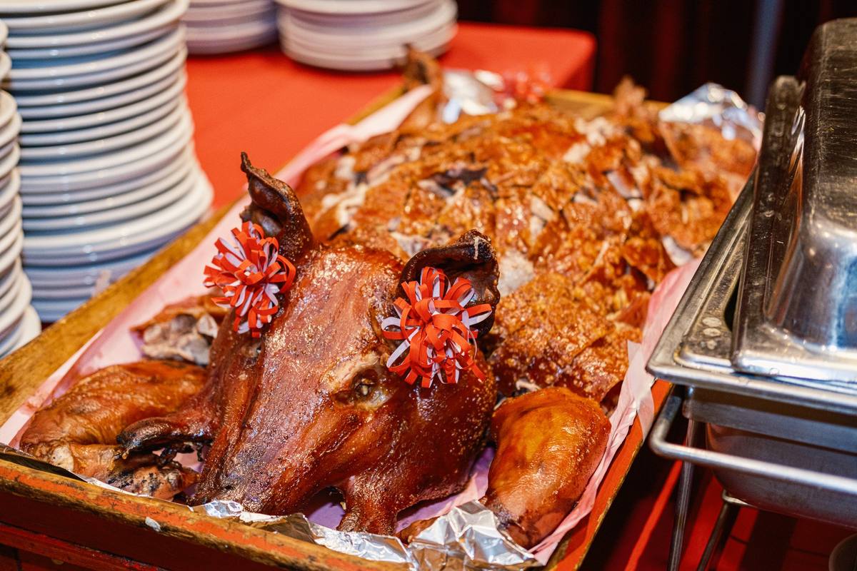 Roast pig and roast duck laid out on the buffet