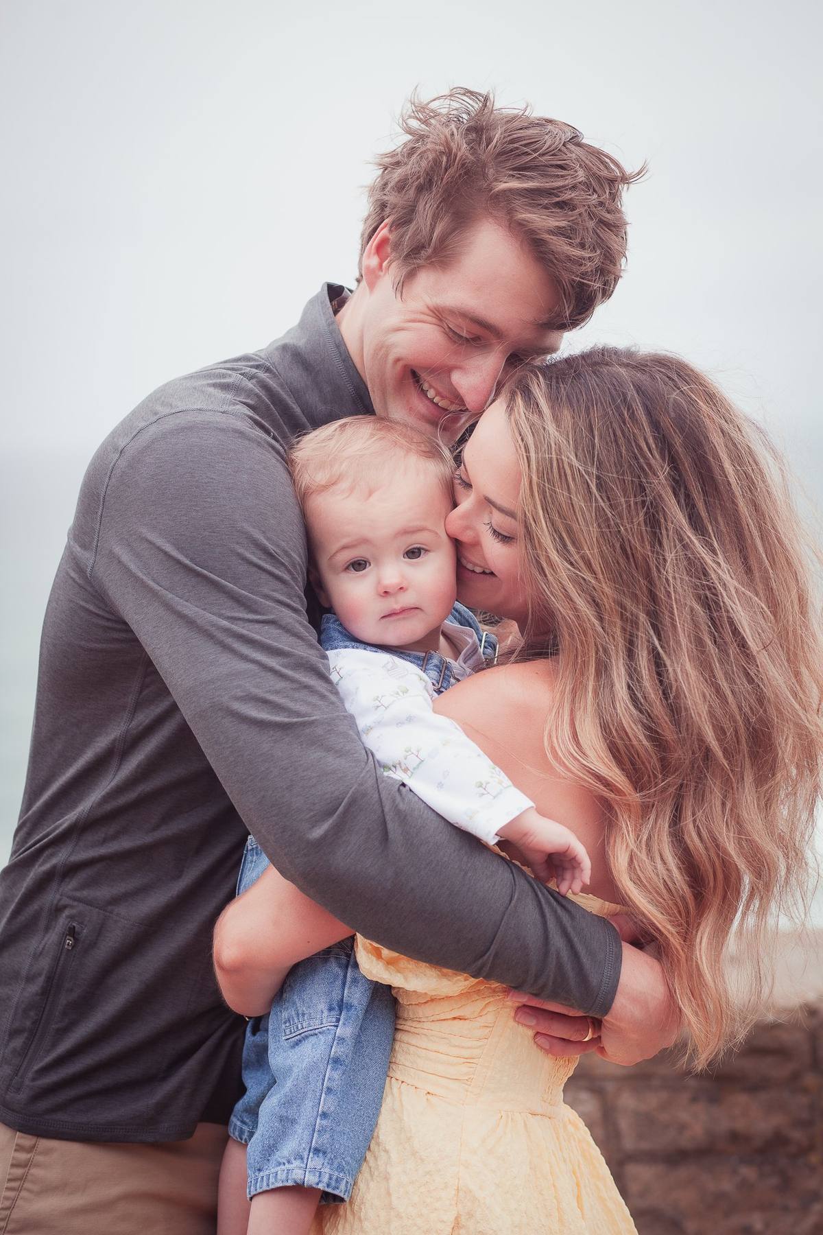 Parents hugging their baby son between them at Sutro Park