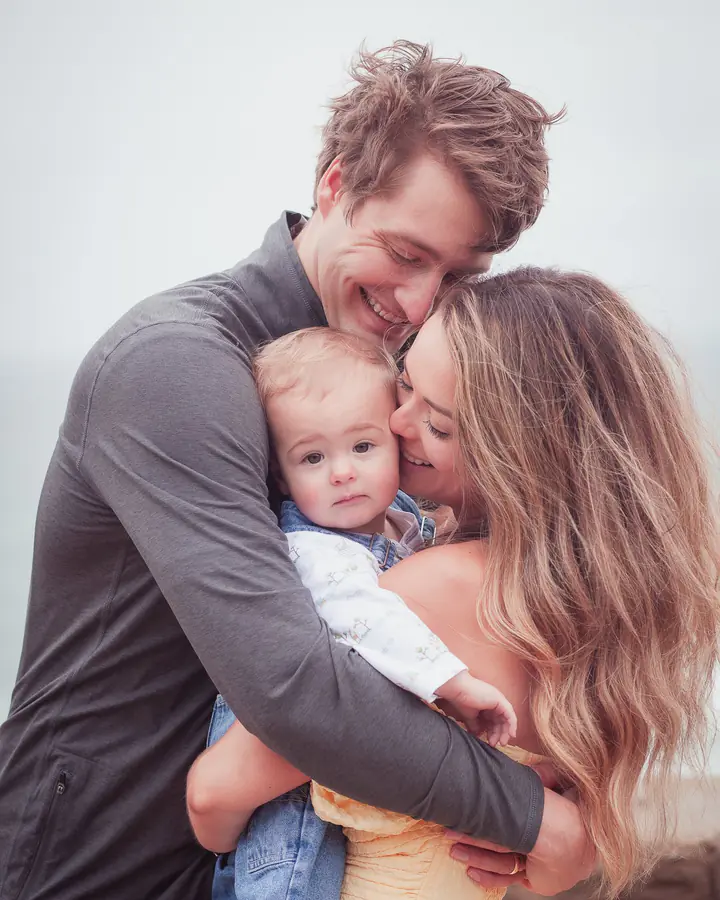 Parents hugging their baby son between them at Sutro Park