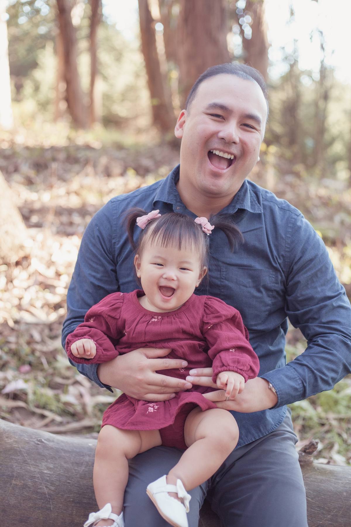 Father laughing with his baby daughter on his lap at Andy Goldsworthy's Wood Line