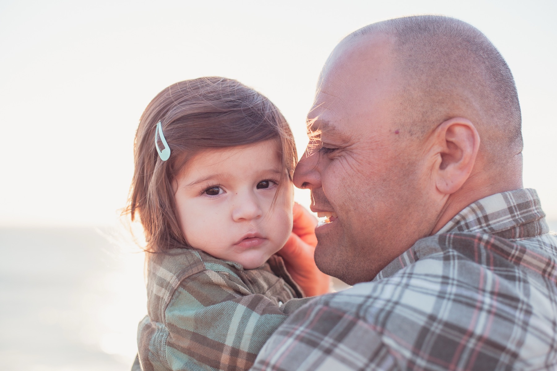 Father comforting his baby girl outdoors