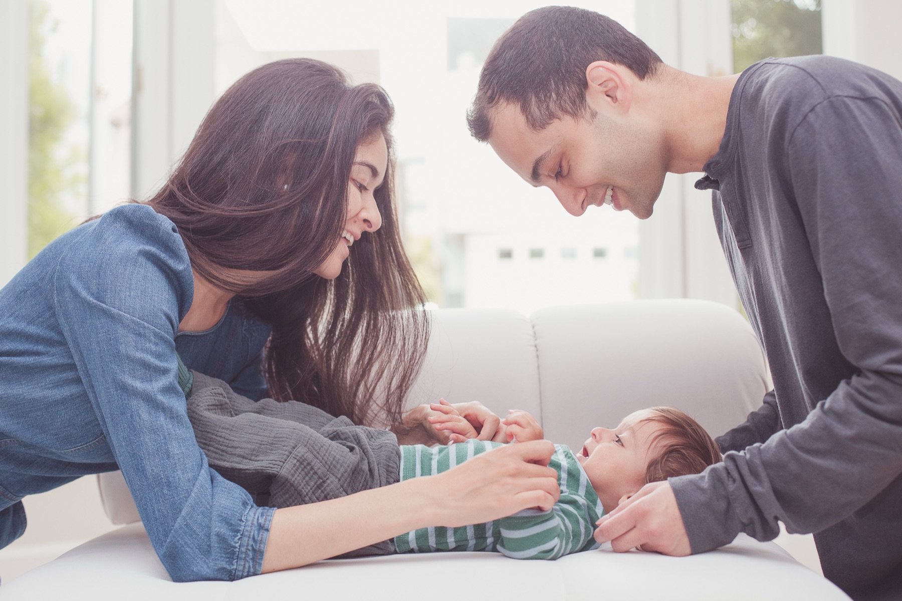 Parents playing with their baby at home
