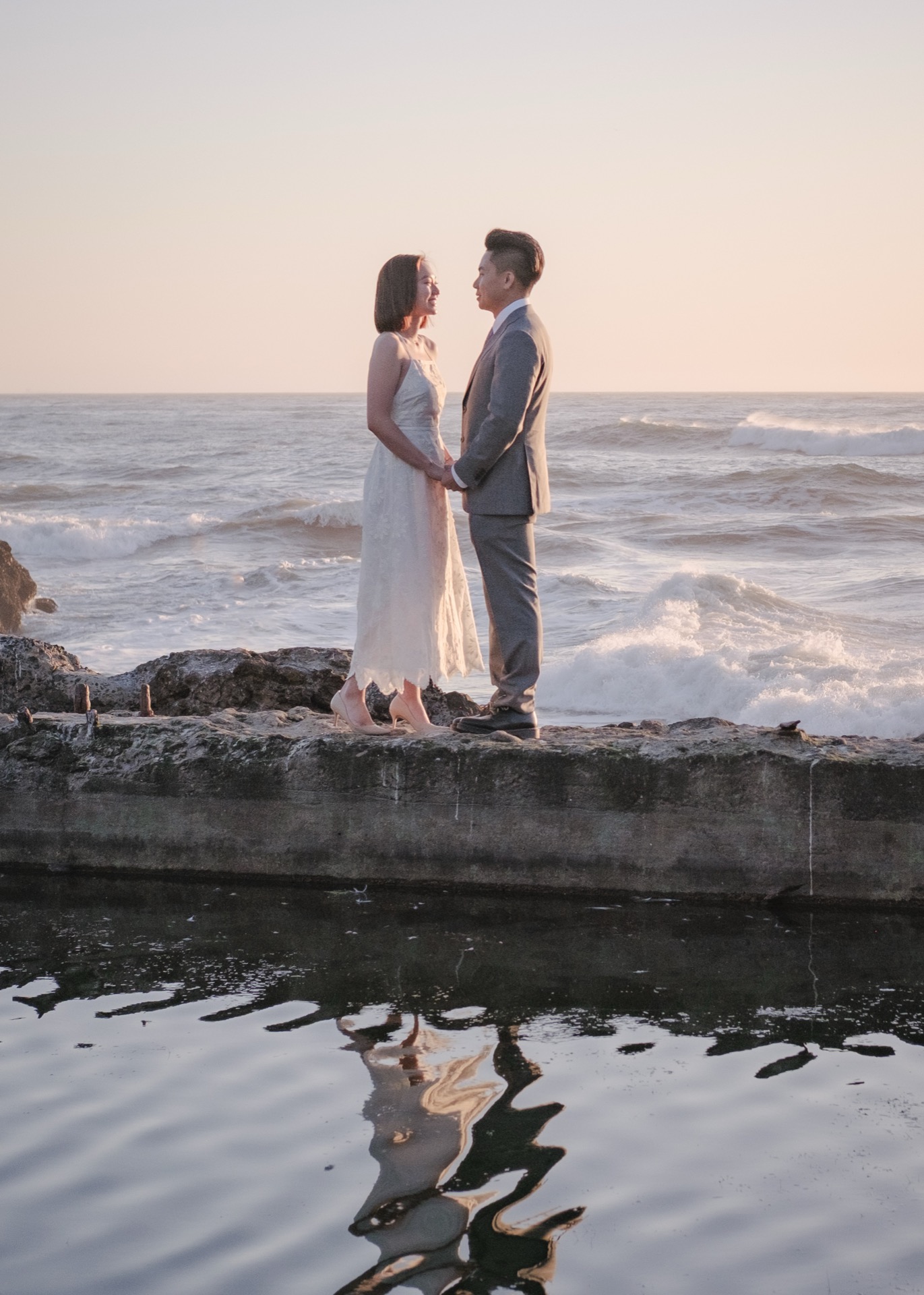 Elaine and Sims at sunset on the rocks along the San Francisco coastline, engagement photography by Matt Dea