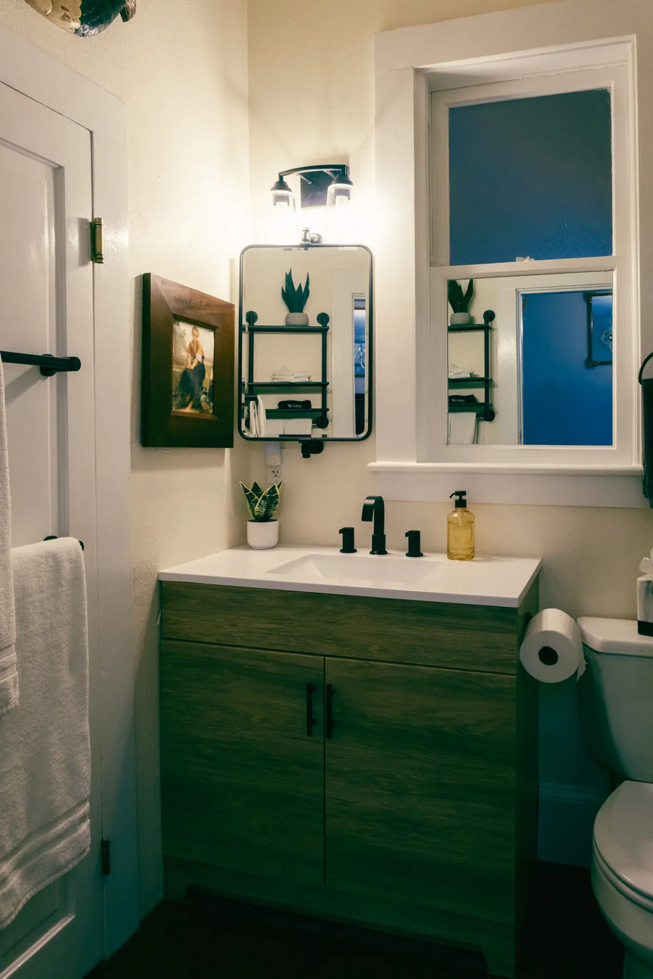 The room's bathroom with a wood vanity