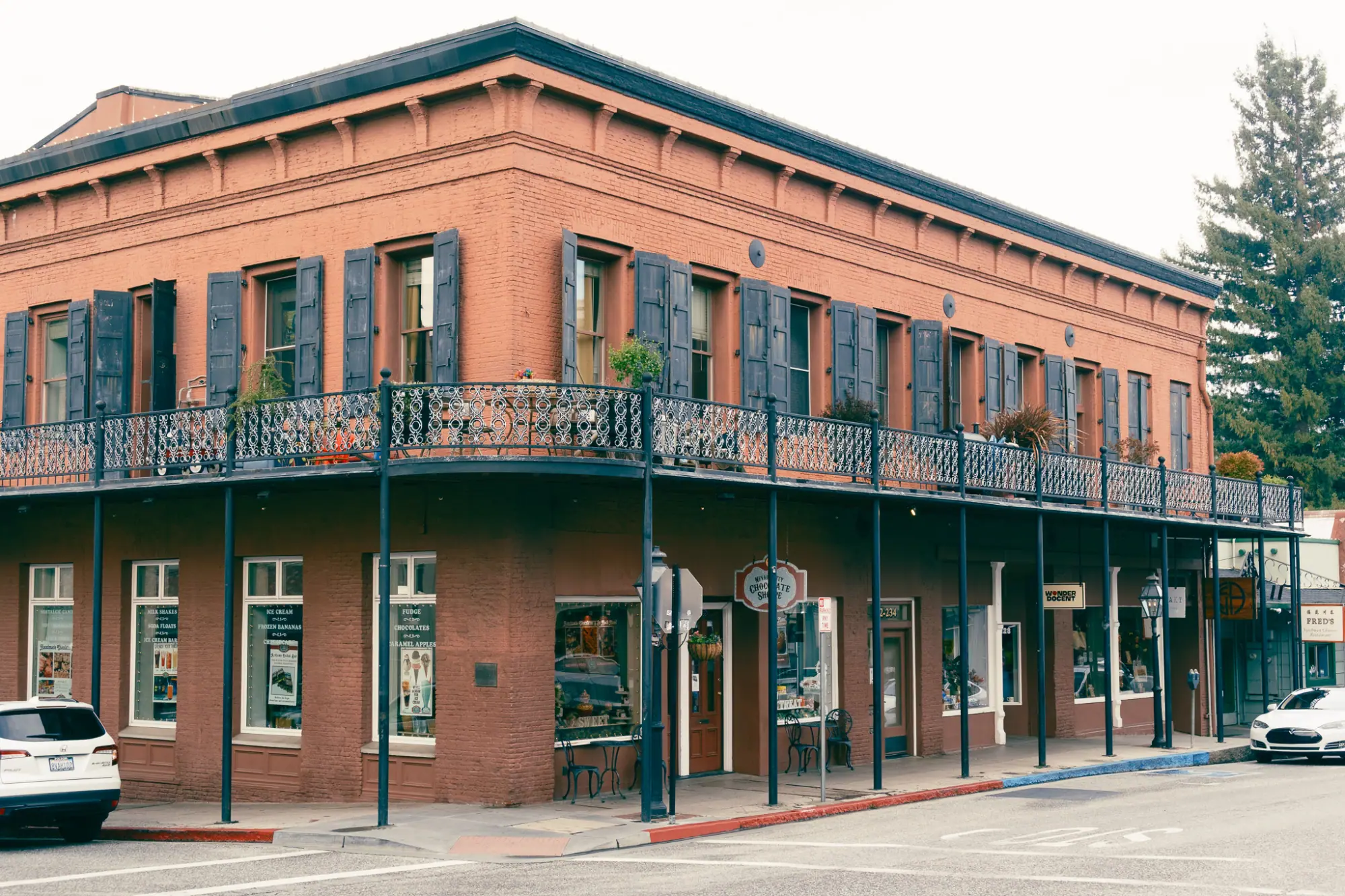 A two-story brick building with iron balconies