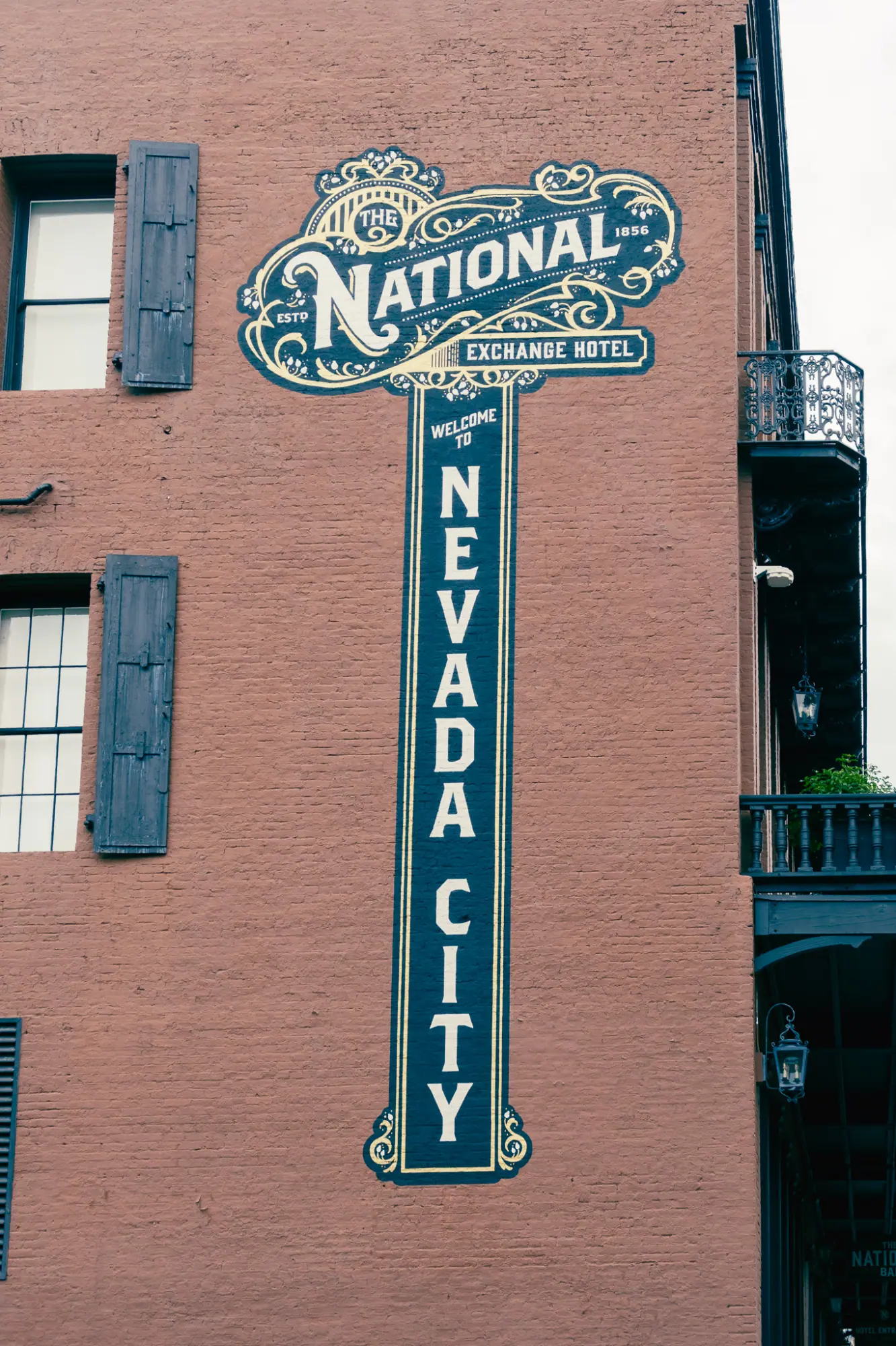 A painted National Hotel sign on a brick wall