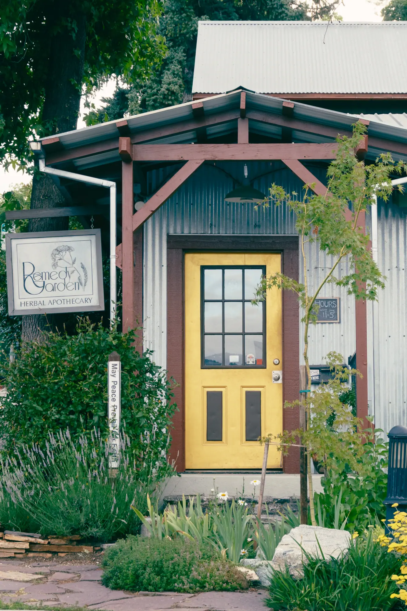 A yellow door under a small gabled porch