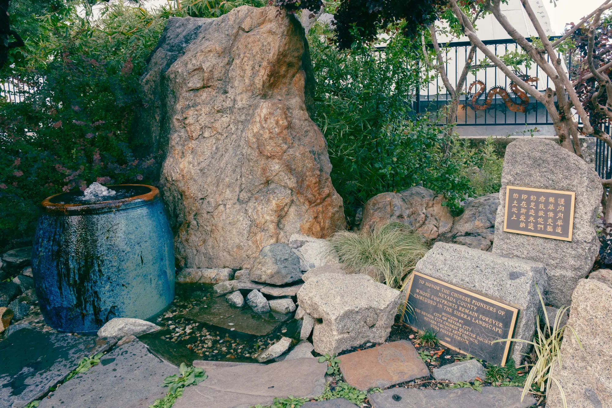The Chinese Monument: a large stone, a small fountain and plaques in English and Chinese