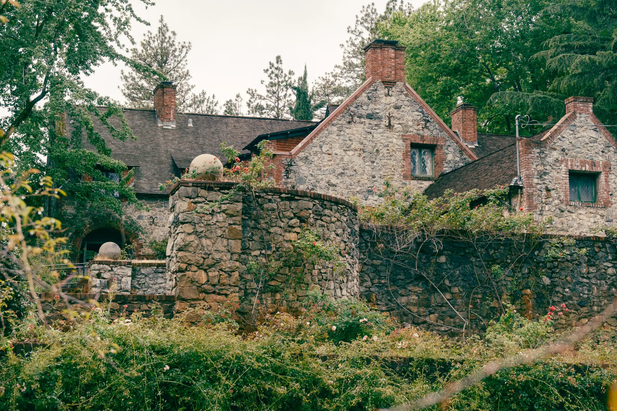 Bourn Cottage behind a stone wall