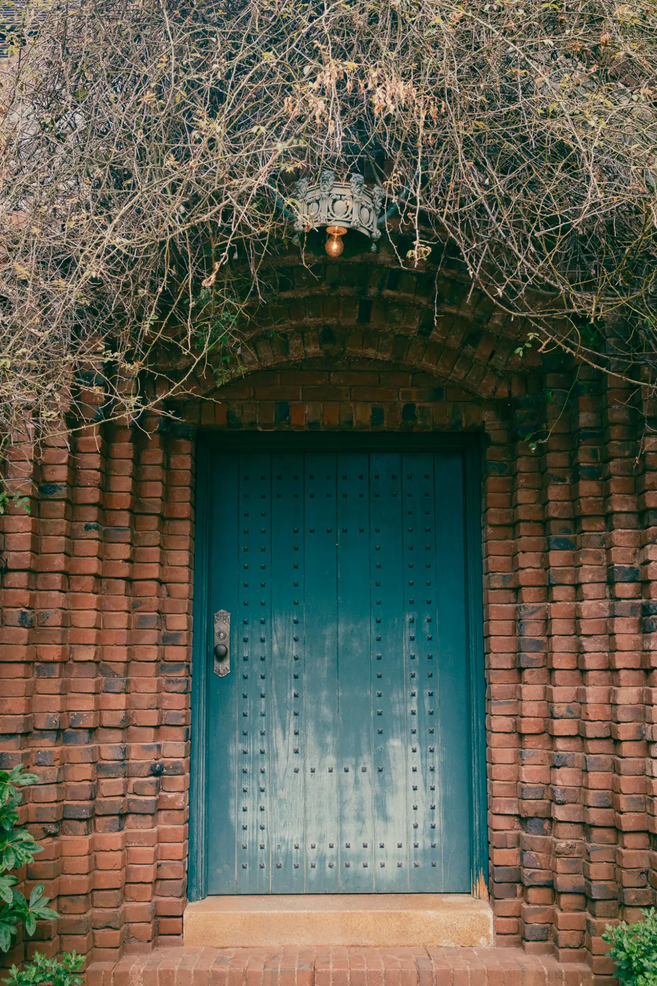 A blue door in a brick archway