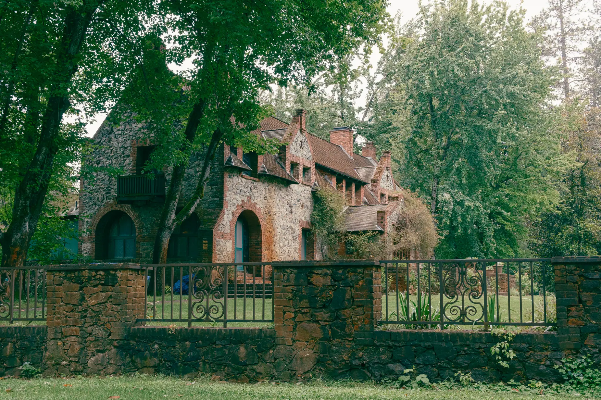 Bourn Cottage behind an iron fence