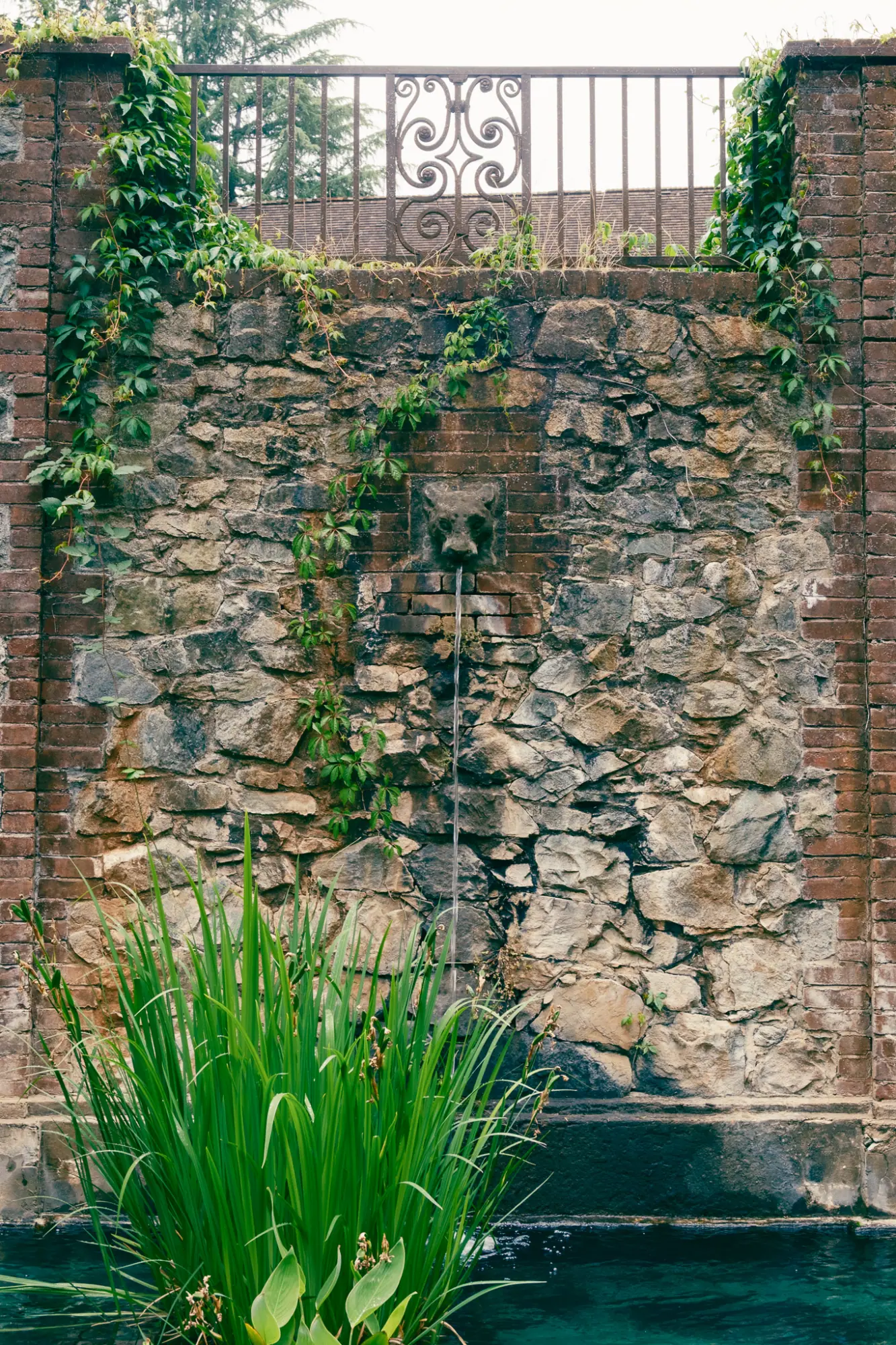 A stone wall above the pool