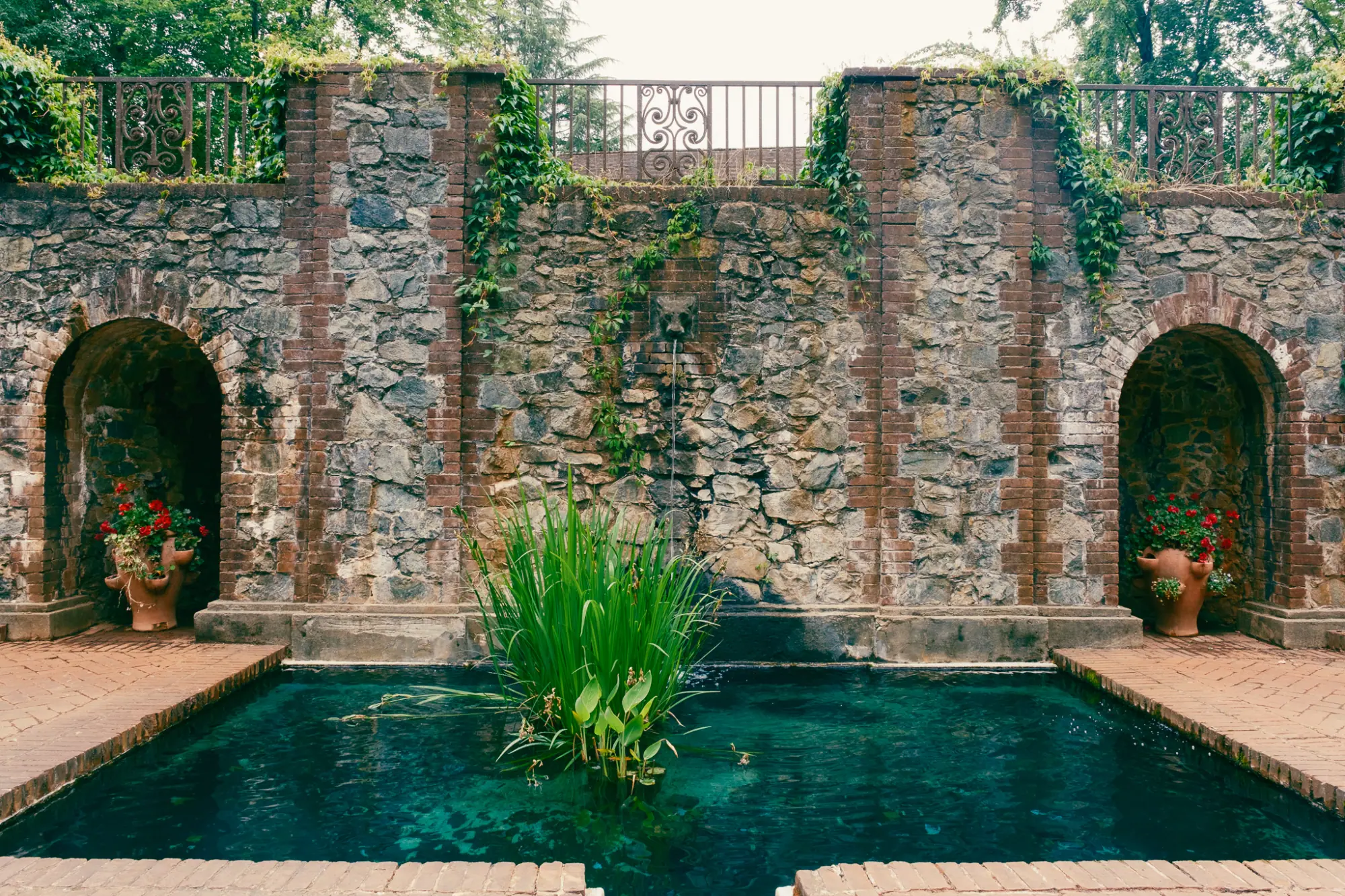 Niches in the stone wall above the pool