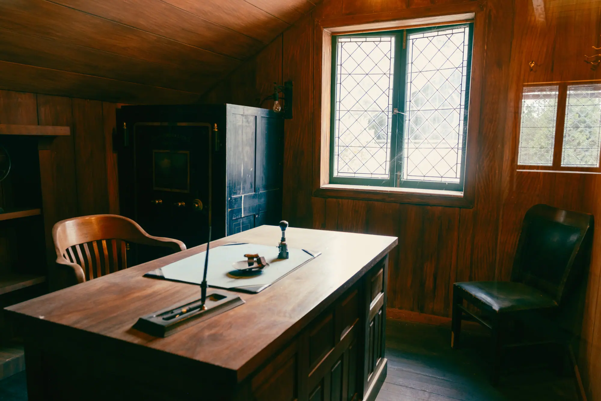 A wood-paneled office with a desk