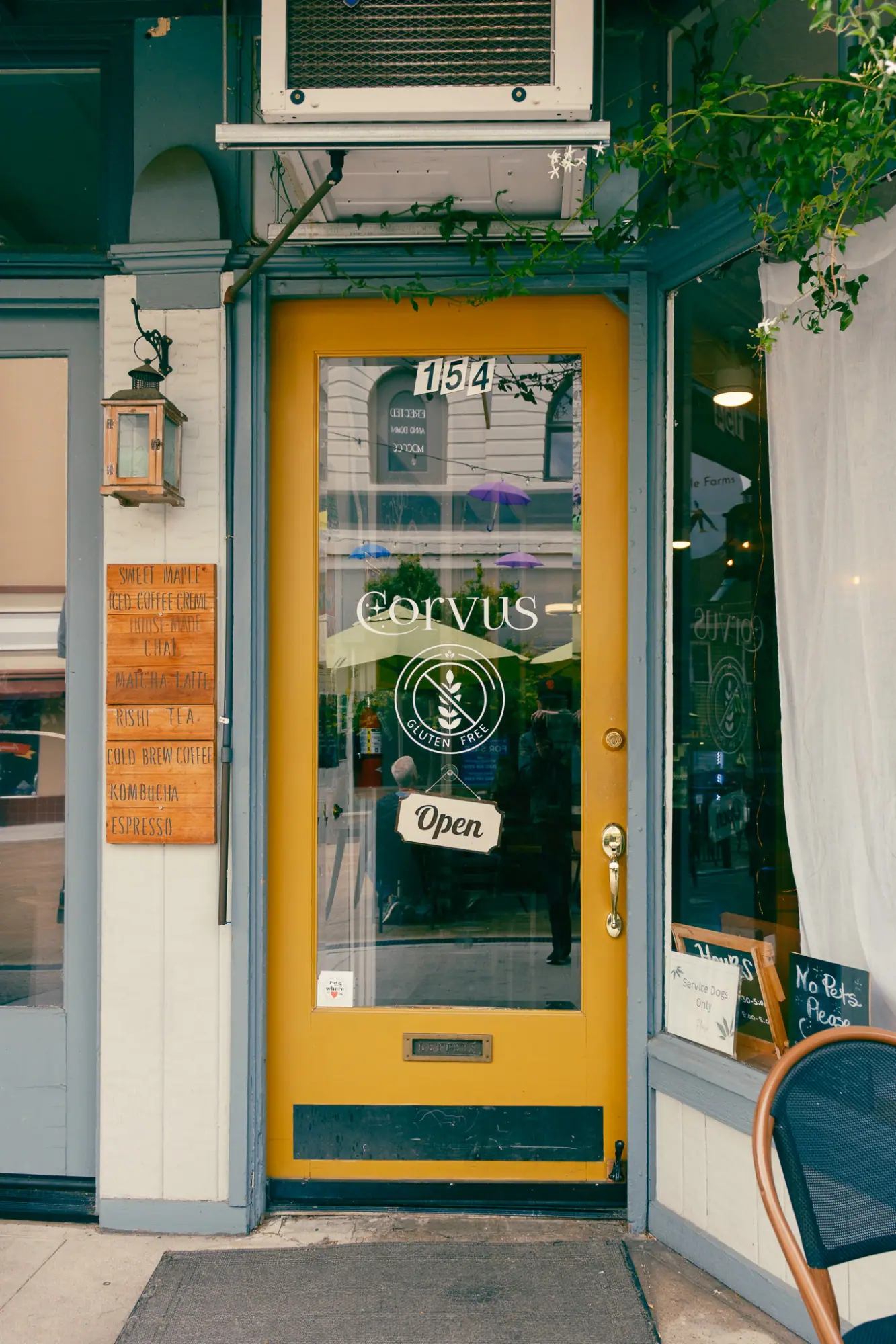 Corvus's yellow front door with a gluten free logo