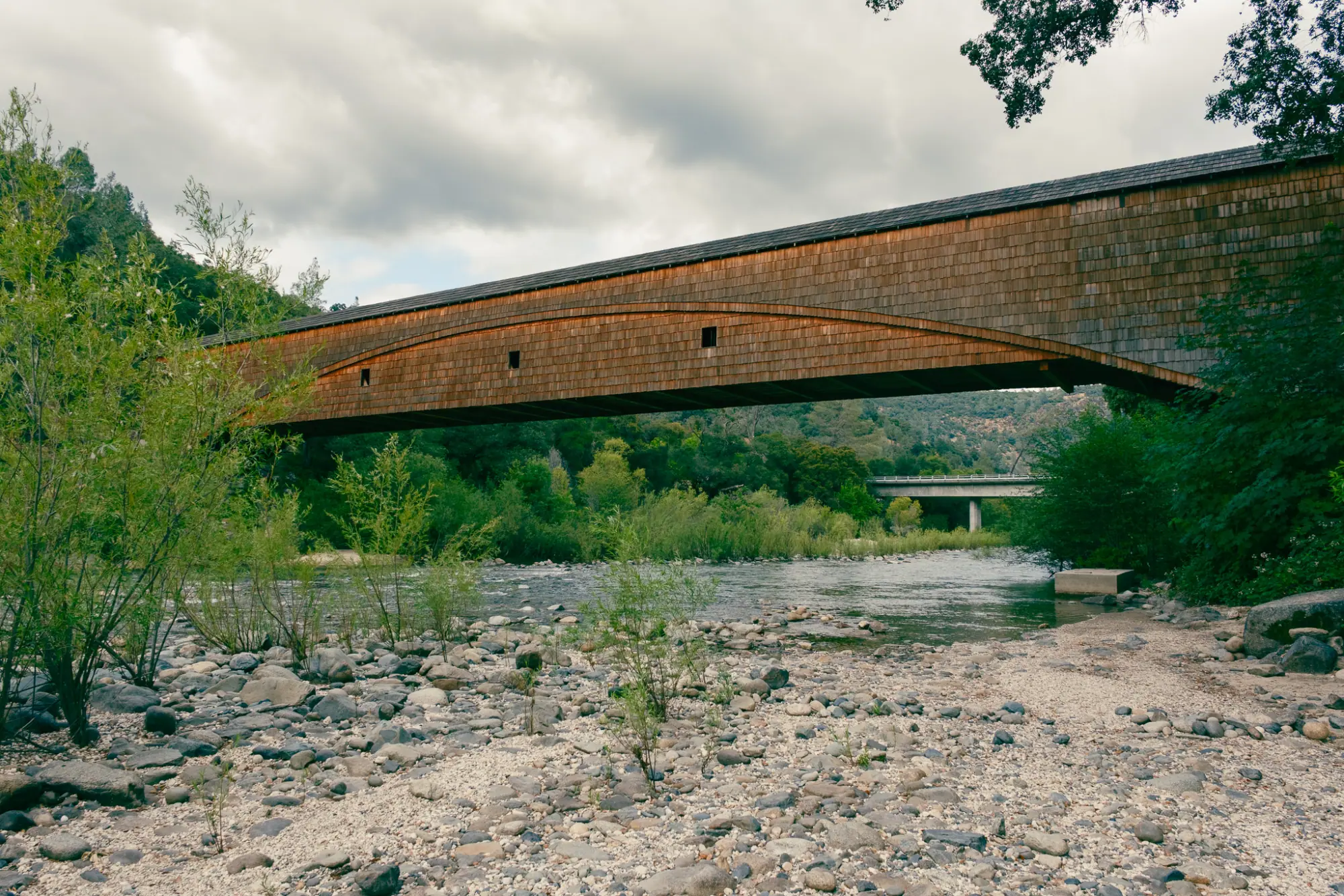 The covered bridge from the riverbank