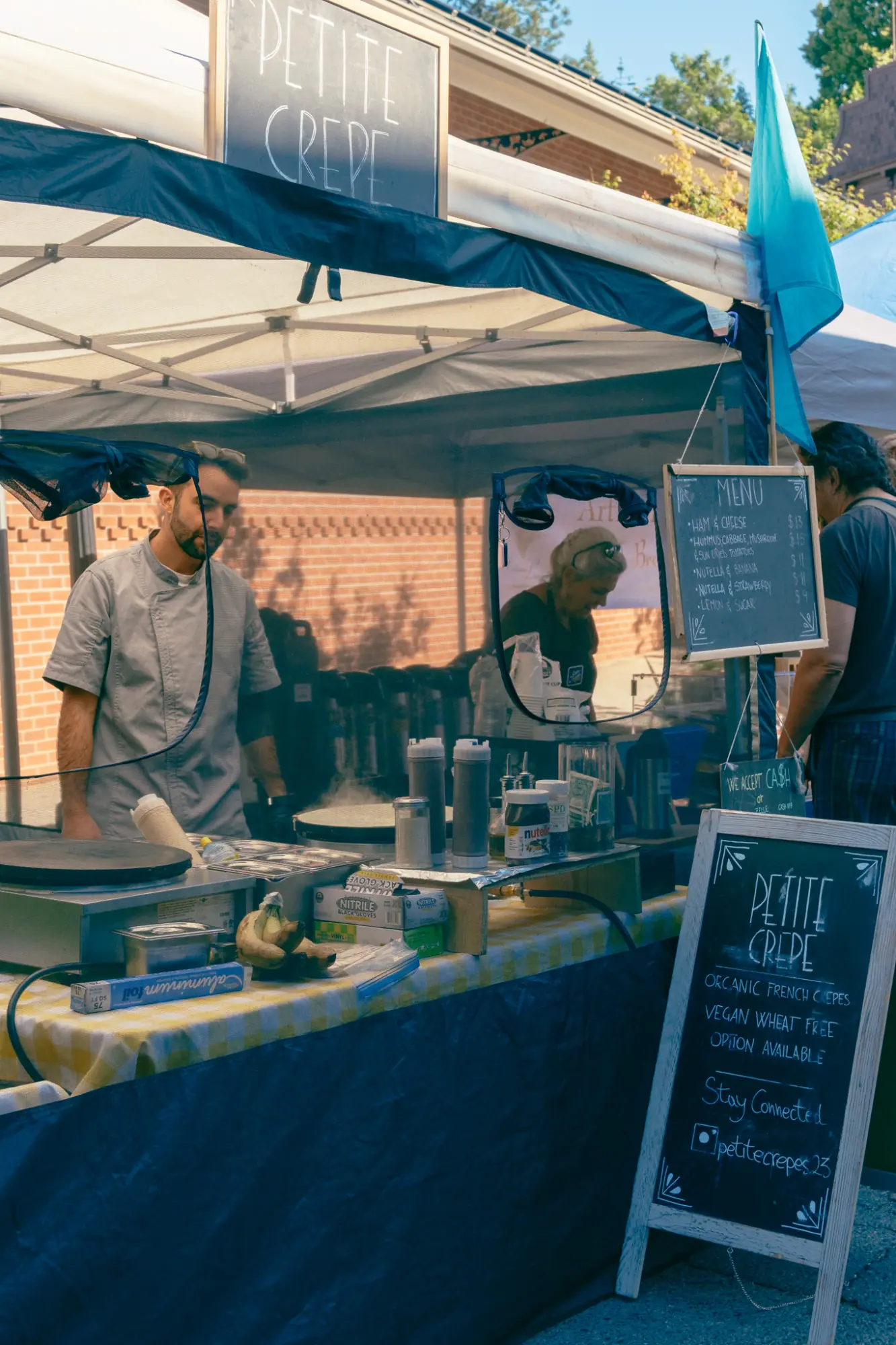 A vendor cooking at the farmers market