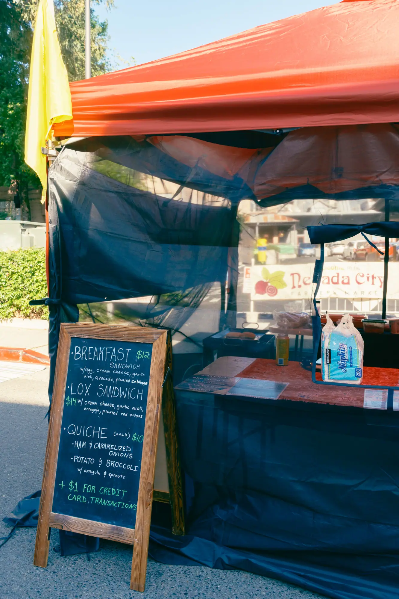 A market stall with a chalkboard menu