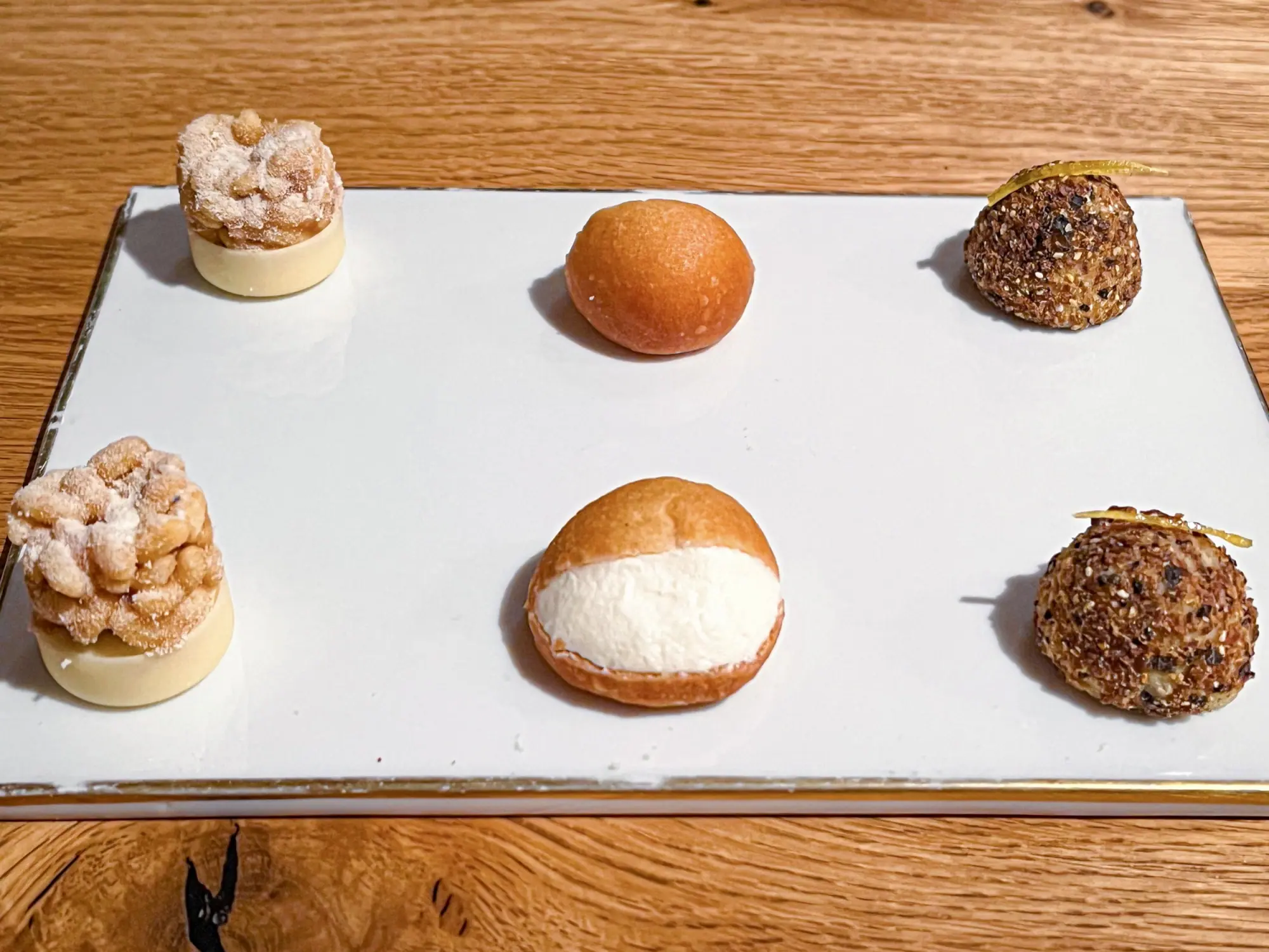 One Last Sweet Surprise Just when we thought it was over… A final parade of playful bites — powdered fritters, citrus-laced puffs, and dreamy filled brioche — served after “Surprise Surprise.” Because dessert deserves an encore.