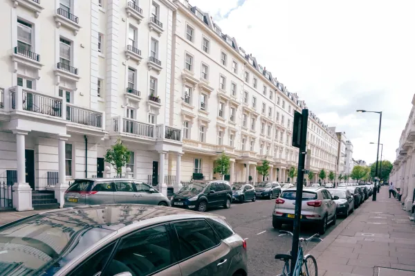 Long white Regency terrace with parked cars
