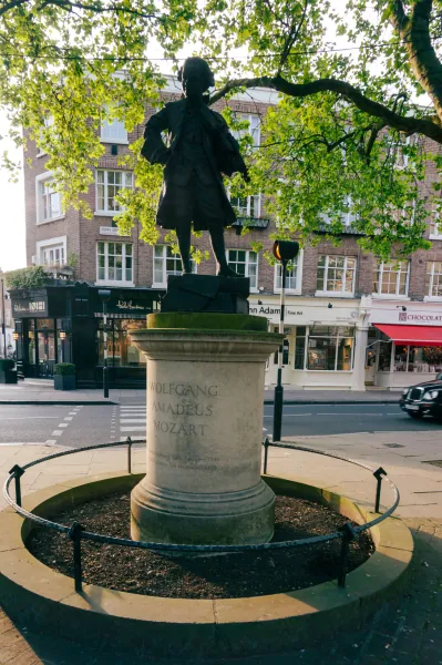 Bronze statue of the child Mozart on a stone plinth