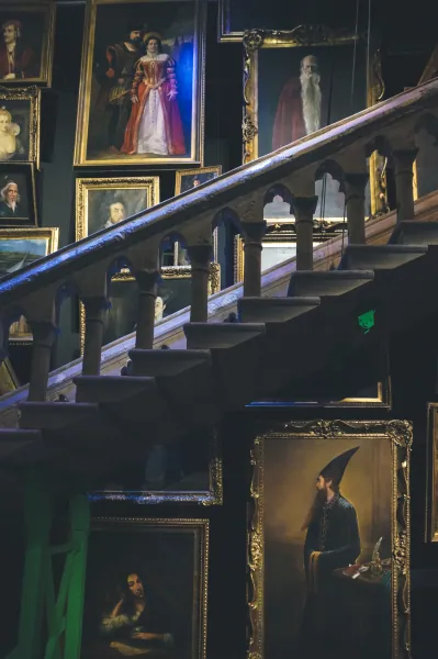 Staircase lined with moving-portrait props