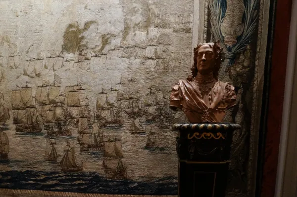 Tapestry of ships with a bronze bust