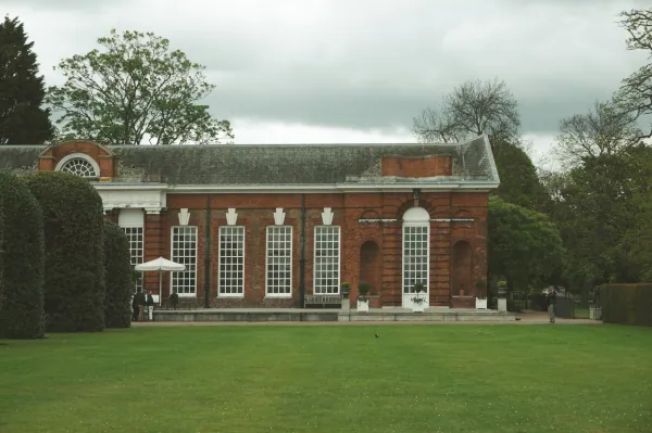 Red-brick Orangery across a lawn
