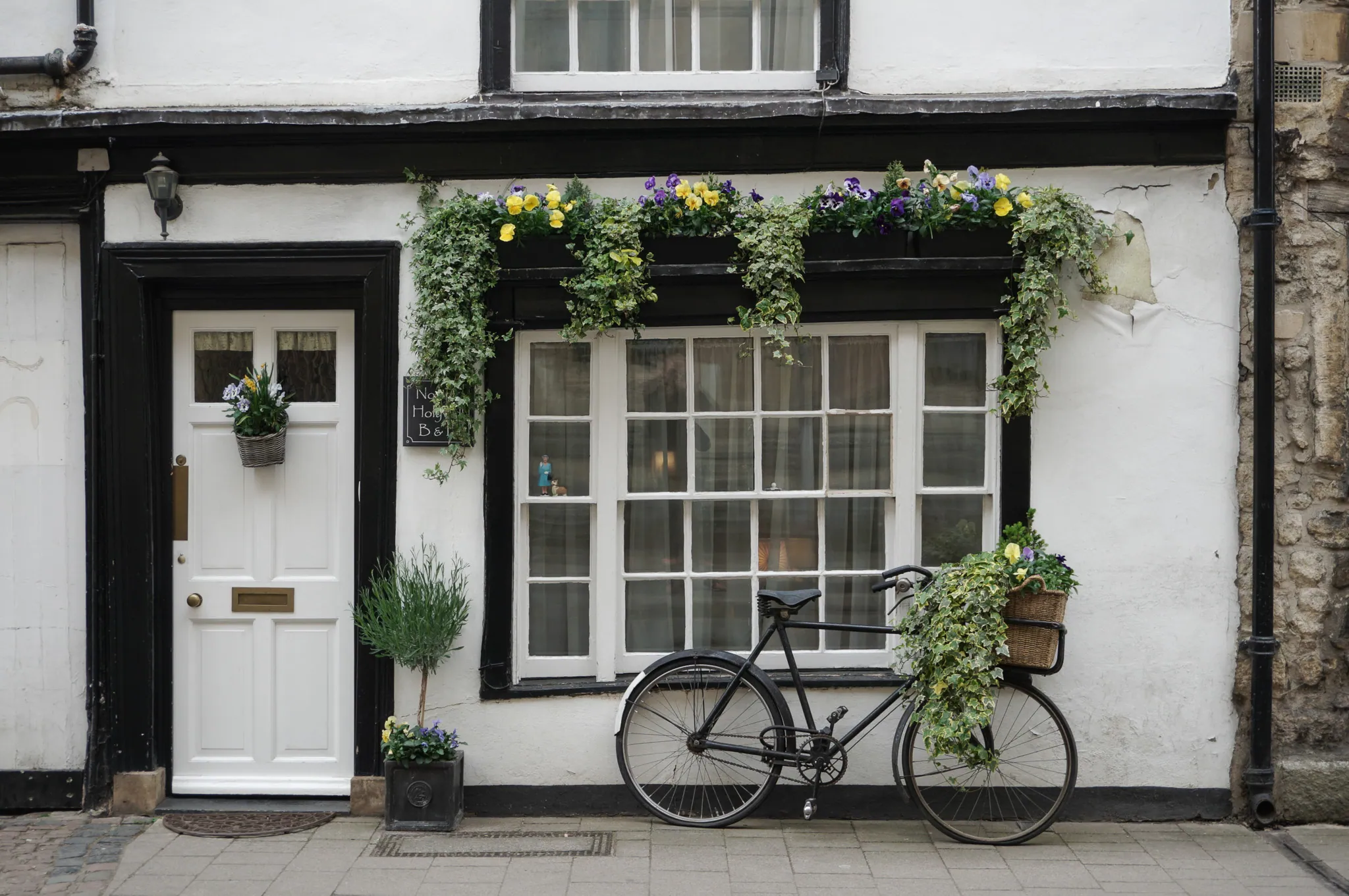 White cottage, bike with flower basket