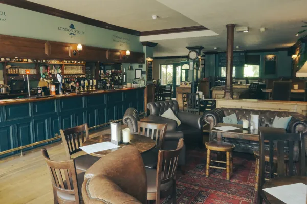 Bar with London Stout sign and leather chairs