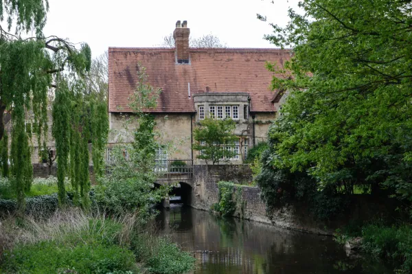 Old stone building over the river with willows