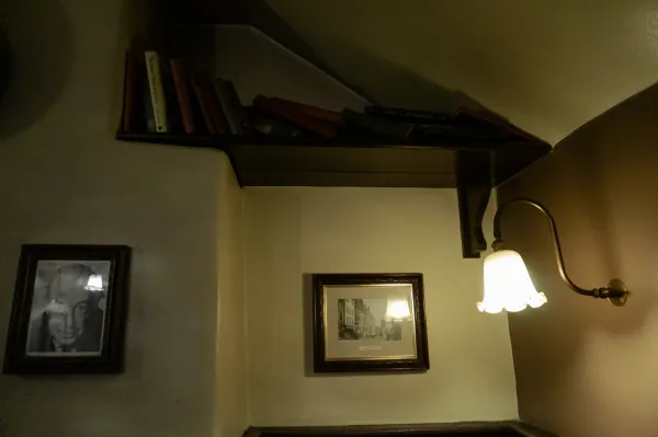 Books on a shelf and framed photos