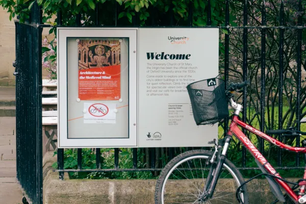 Church welcome sign with a red bike