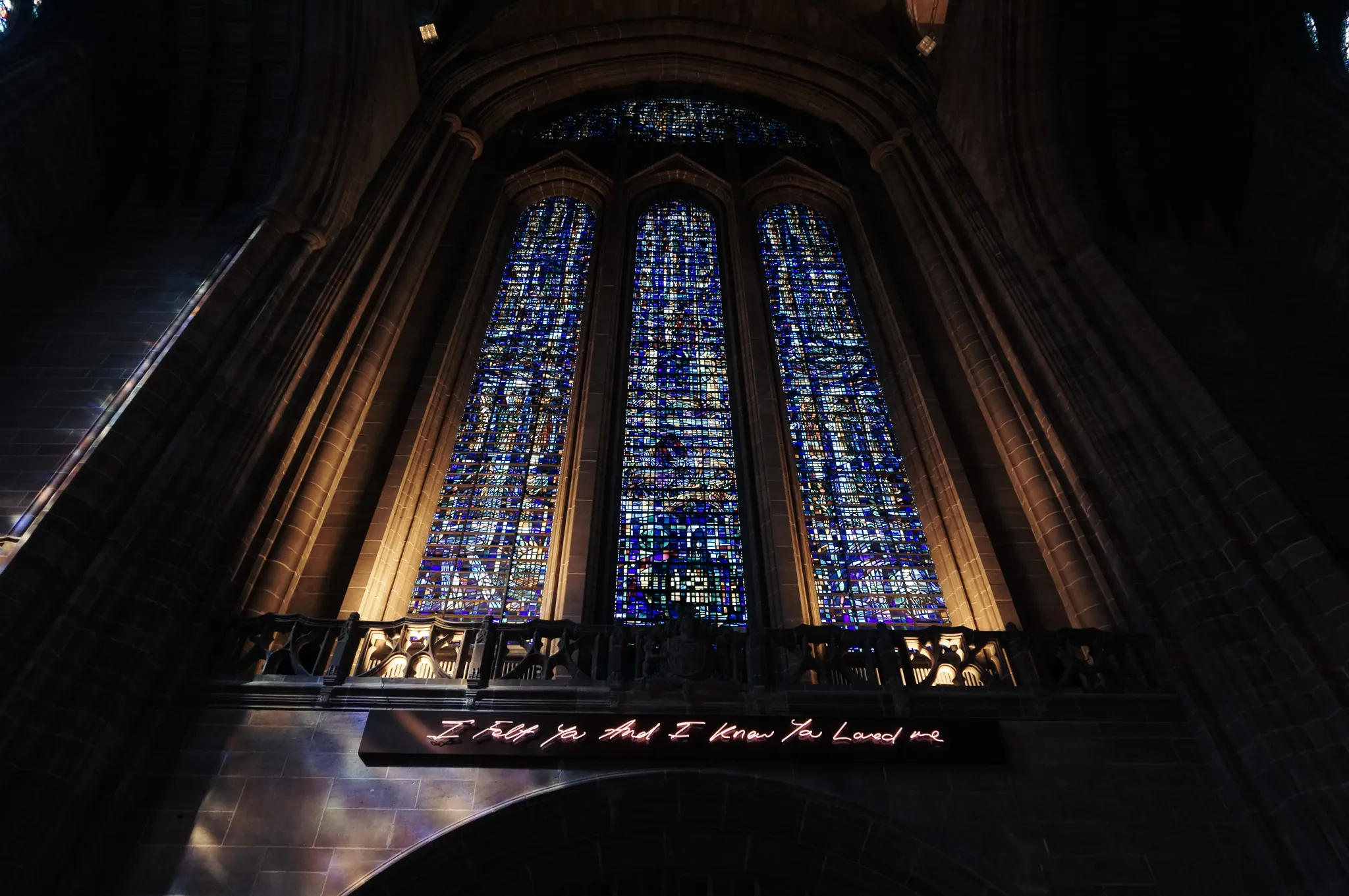 Window with "I felt you and I know you loved me" neon