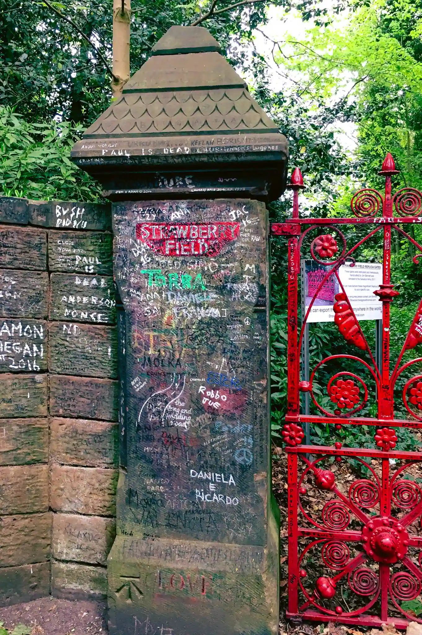 Gate pillar with red ironwork