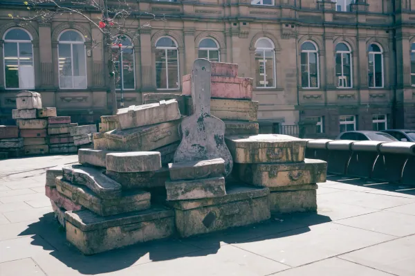 Pile of stone suitcases sculpture