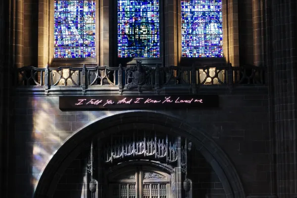 Emin neon above an arched doorway