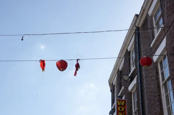 Red lanterns strung over a street