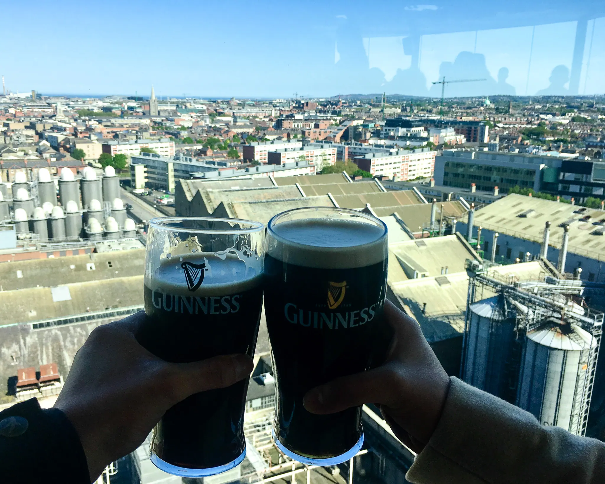 Two pints raised over the city view