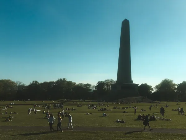 Obelisk with people on the grass