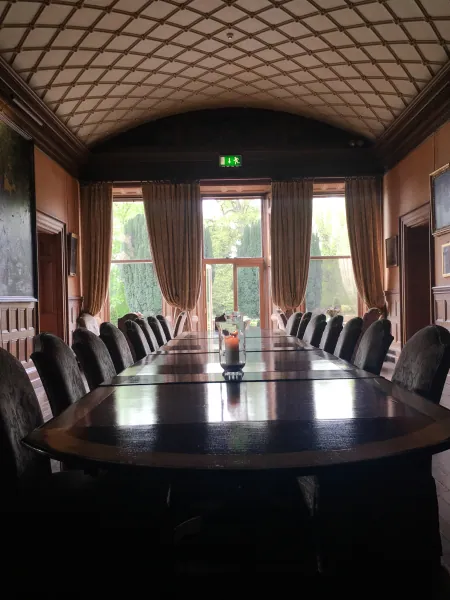 Long boardroom table with curtained windows