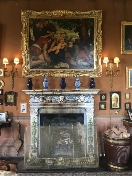 Tiled fireplace under a large painting