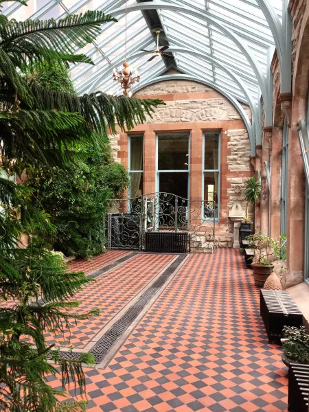 Glass-roofed corridor with chequered tiles