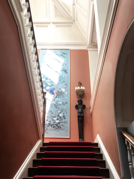 Narrow red stair with painted panel